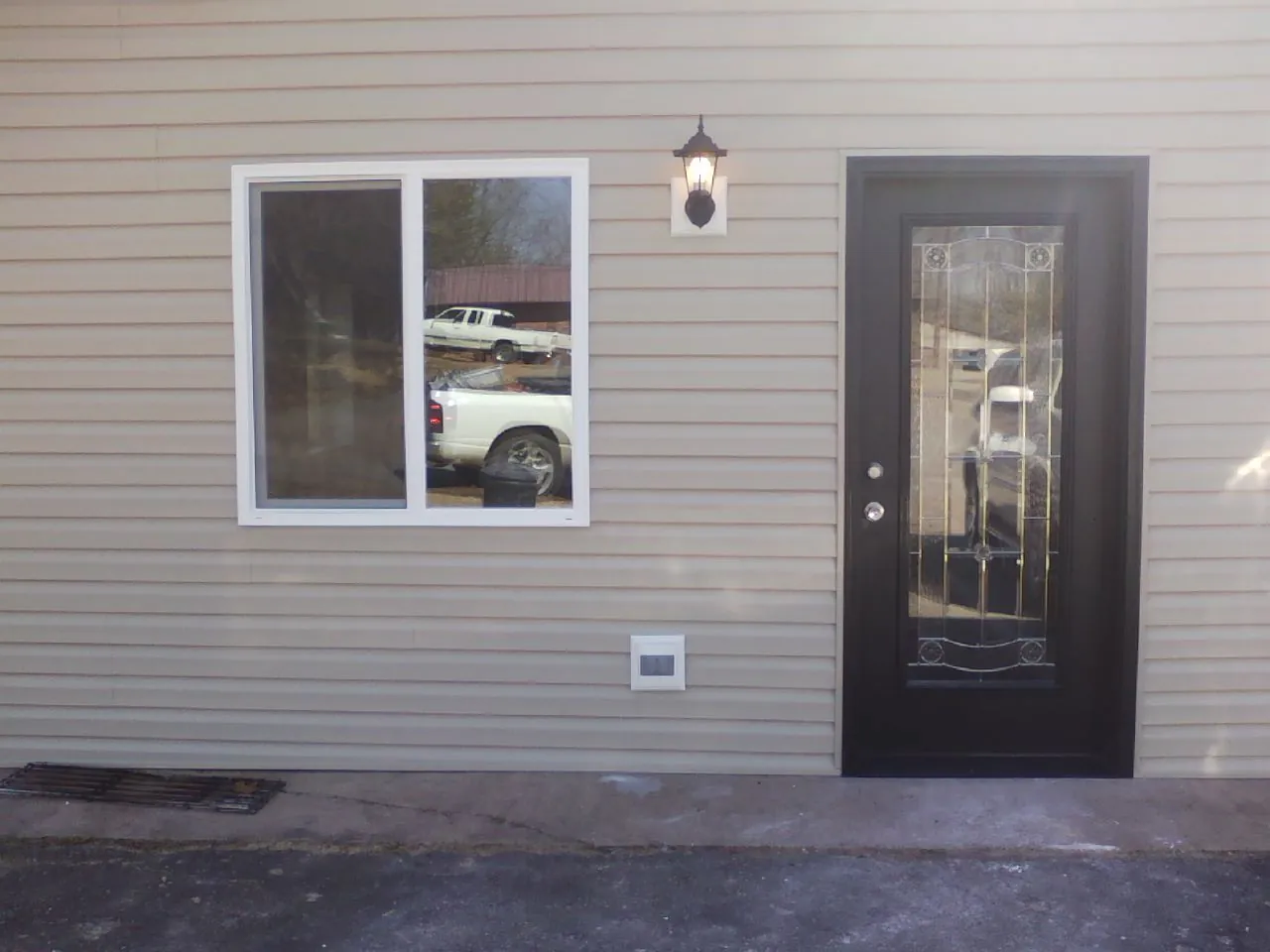 New siding, window and entry door on the side of an addition in Castroville